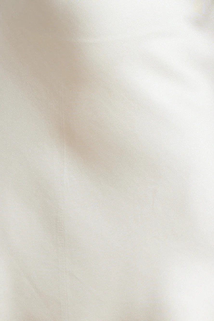 A beige hanging neck short skirt with a tie design at the neck. The skirt body is made of satin material, suitable for parties, dates, etc