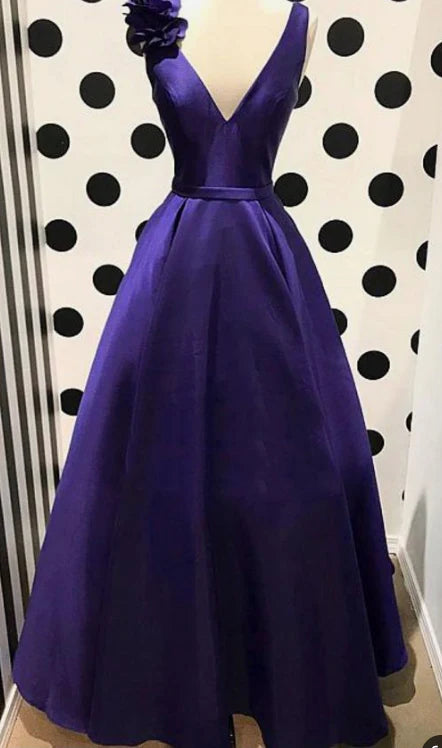 A deep purple satin dress with a deep V-neck, high waist, and large skirt that is suitable for occasions such as dinners and dances