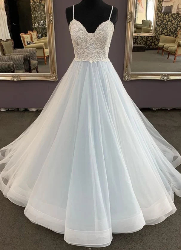 A light blue and white gradient wedding dress with deep V-neck straps and lace embroidery on the upper body,
