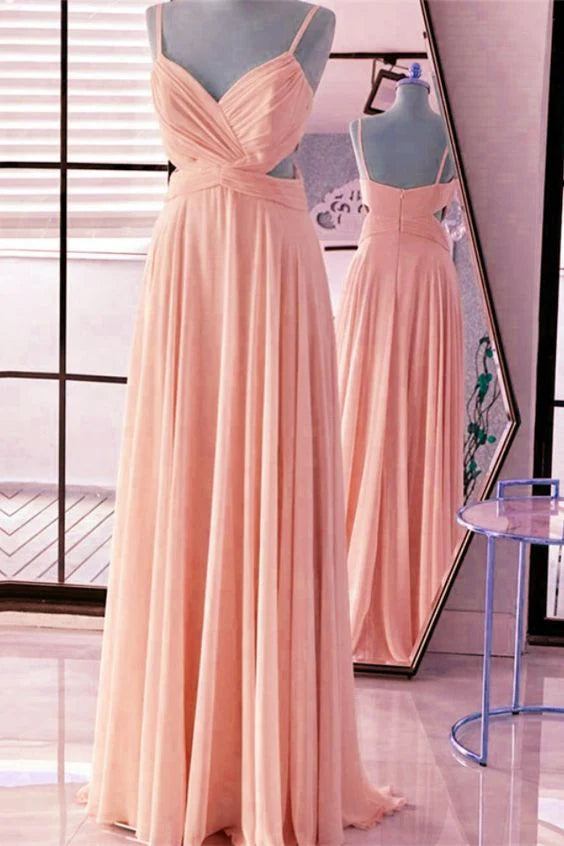 A light pink dress with a deep V-neck strap and a cross cut design at the waist The high waisted skirt is suitable for dinners weddings and more