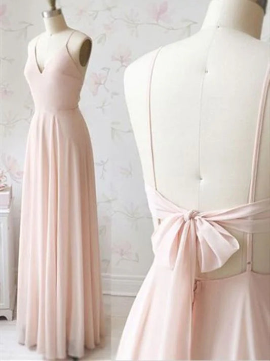 A light pink long dress with a deep V-neck strap and a bow design on the back,