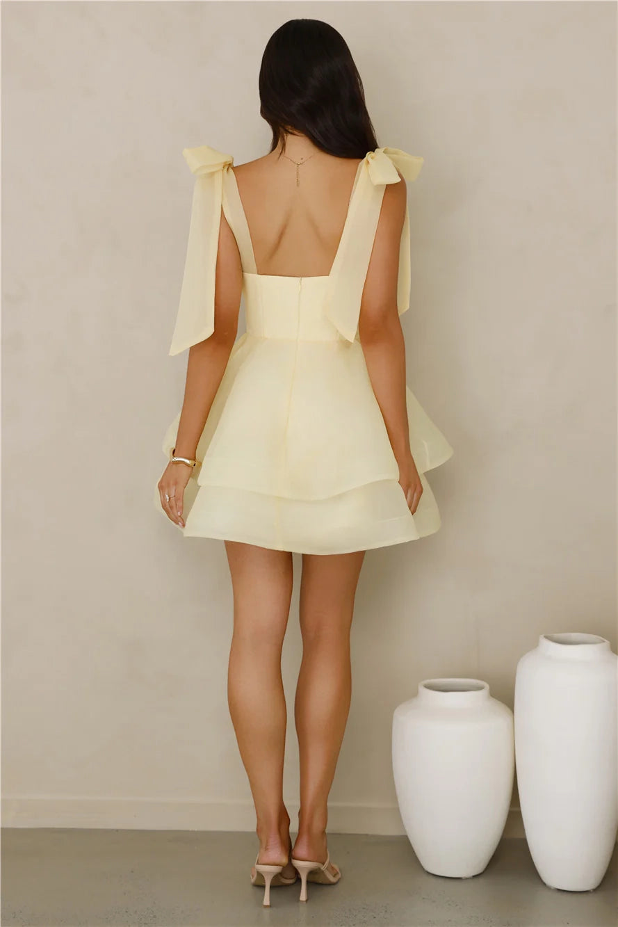 A light yellow short dress with a square neckline and multi-layered fluffy skirt, suitable for parties, dates, etc