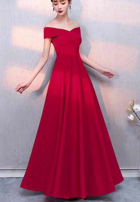 A red formal dress with a one shoulder design and a waist cinching hem, suitable for dinner parties