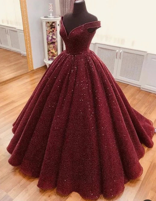 Wine red satin dress with a one shoulder design and a waist cinching hem suitable for dinner parties