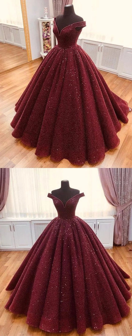 Wine red satin dress with a one shoulder design and a waist cinching hem suitable for dinner parties