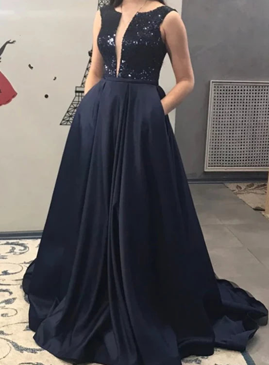 Deep blue sleeveless long dress with a deep V design and shiny sequins. The lower body is a large skirt suitable for dinners, award ceremonies