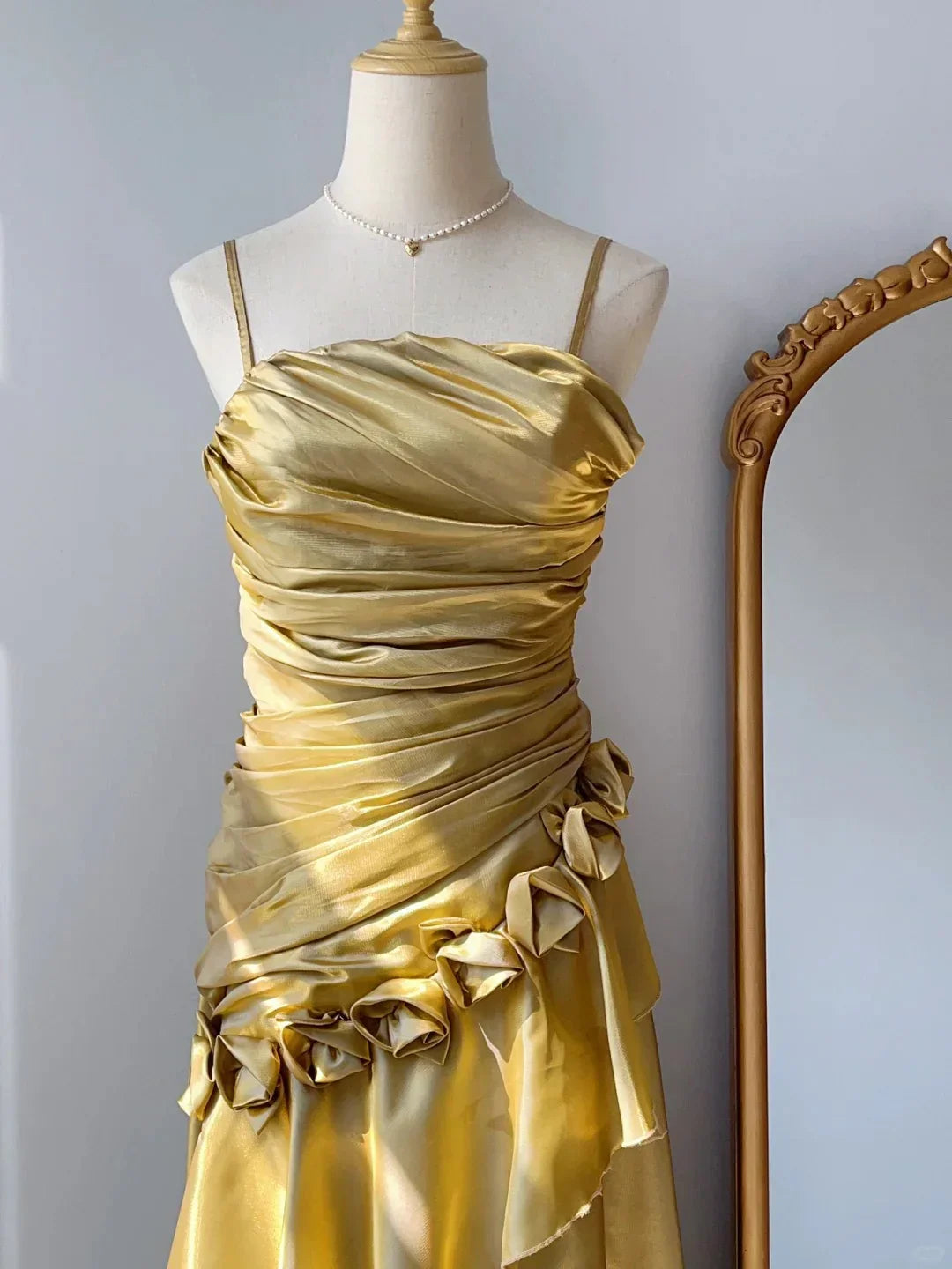 Golden satin camisole dress with pleated design side floral decoration, irregular skirt hem