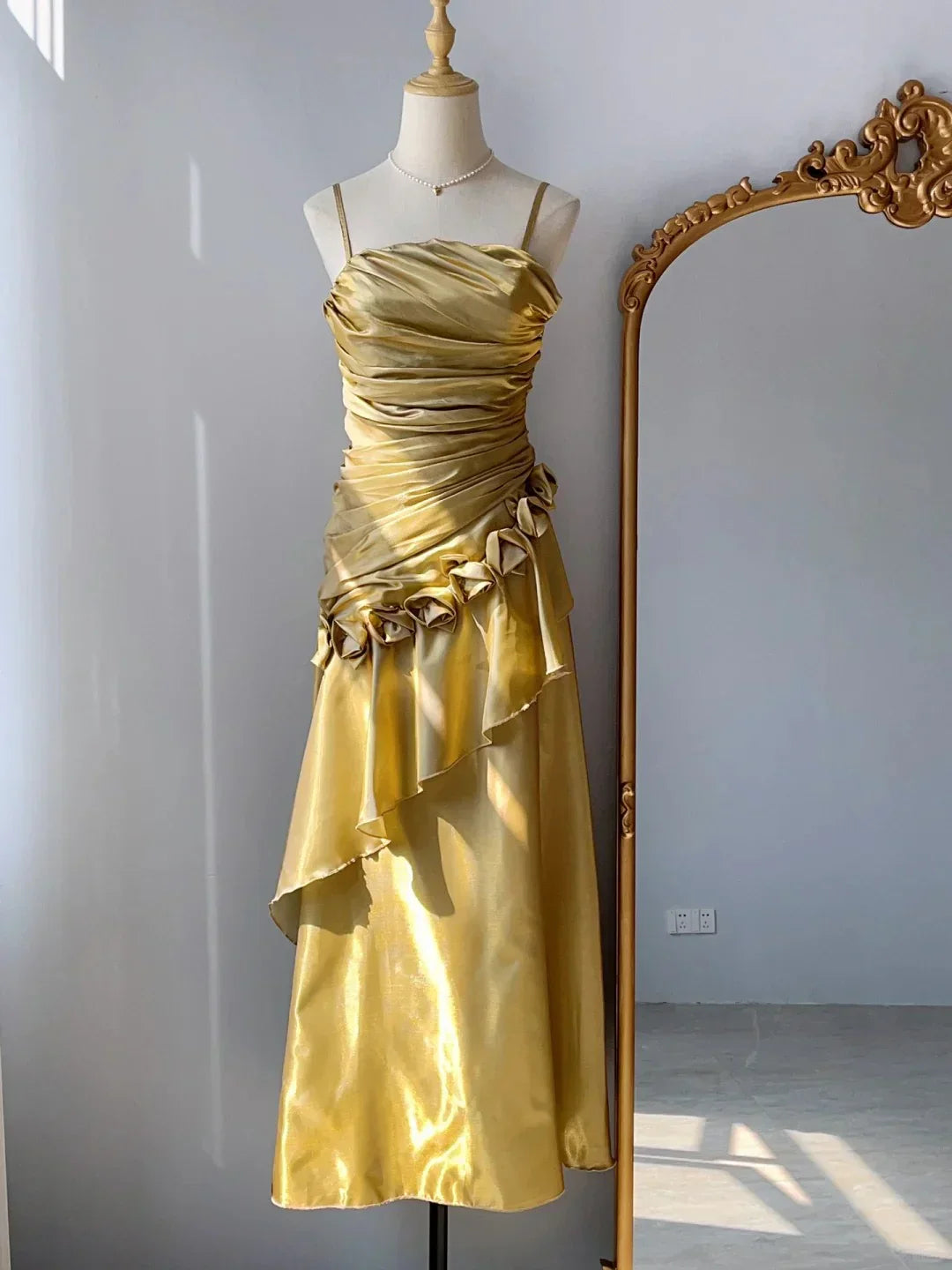 Golden satin camisole dress with pleated design side floral decoration, irregular skirt hem