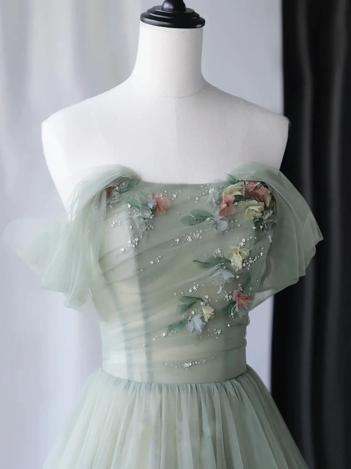 Light green gauze dress with strapless upper body embroidered with floral decorations suitable for dinner parties
