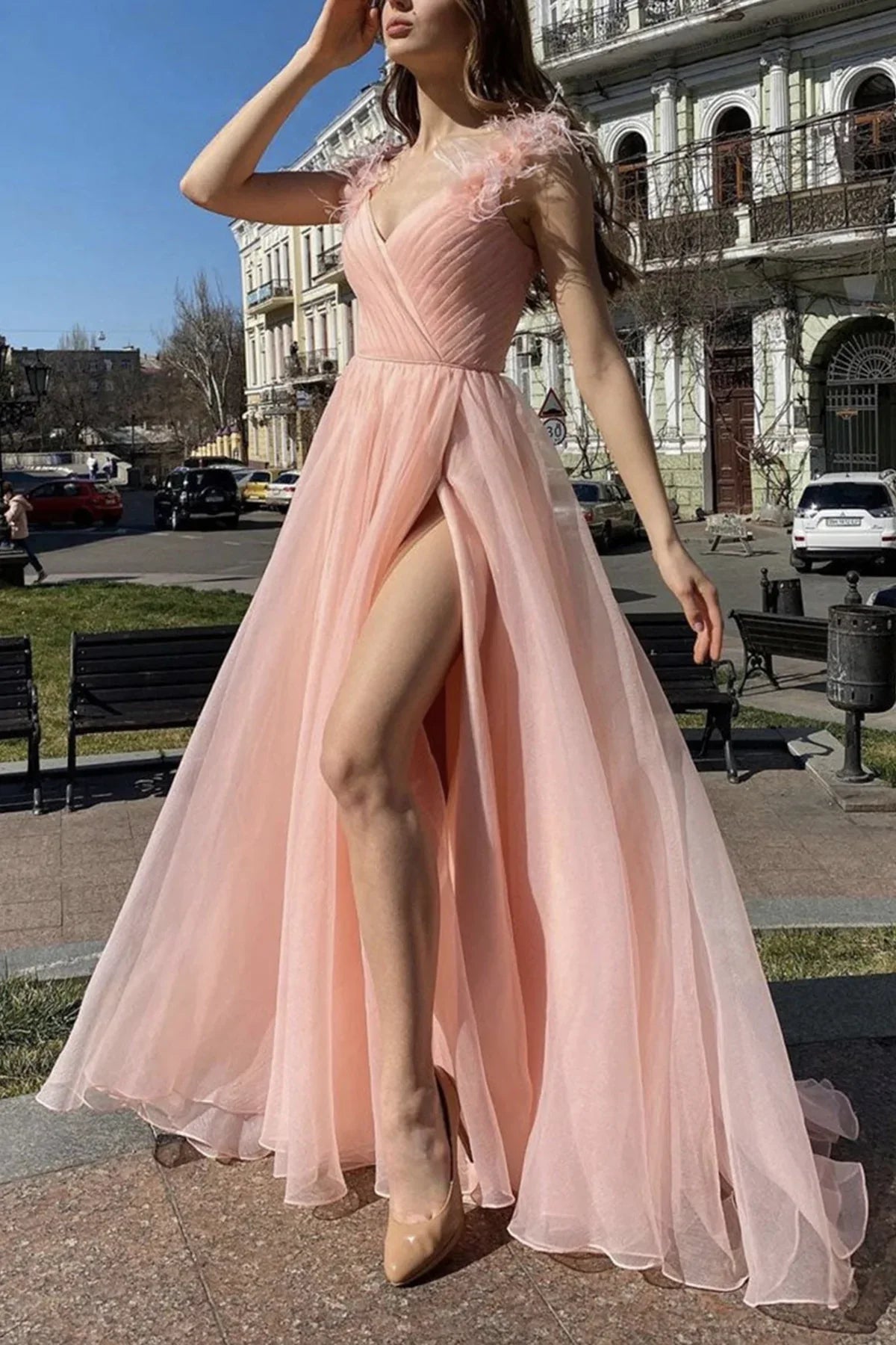 Light pink dress, deep V-neck, sleeveless design, with feather accents on the shoulders
