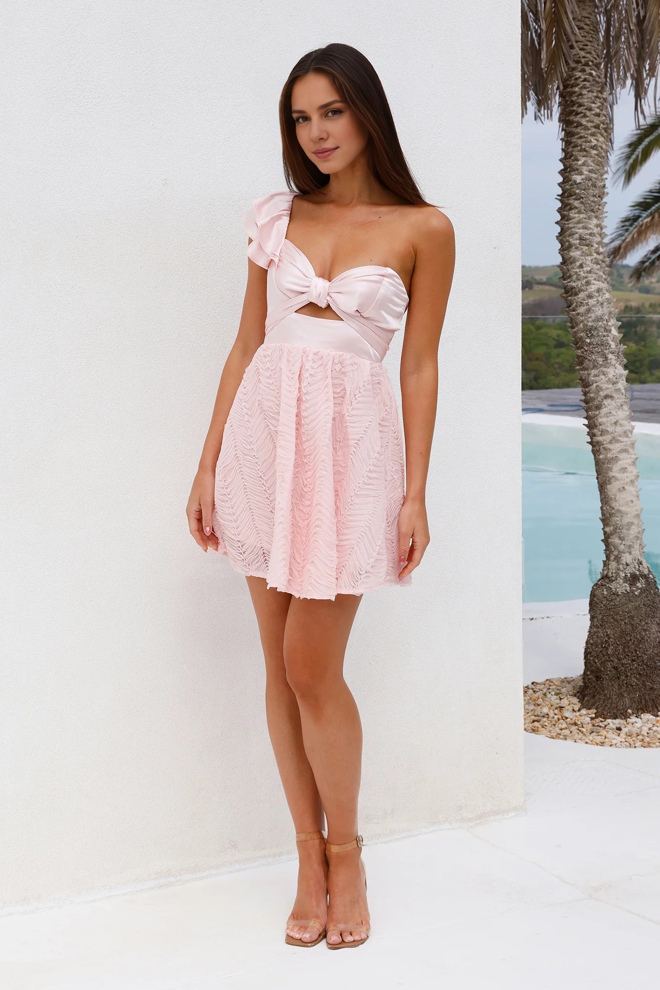 Light pink short dress with a single shoulder strap design and a ruffled edge decoration on one shoulder, suitable for parties, dates, etc
