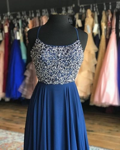 Long suspender dress with sequins or bead decorations on the upper body and a flowing deep blue skirt on the lower body, suitable for dinners, dances, etc