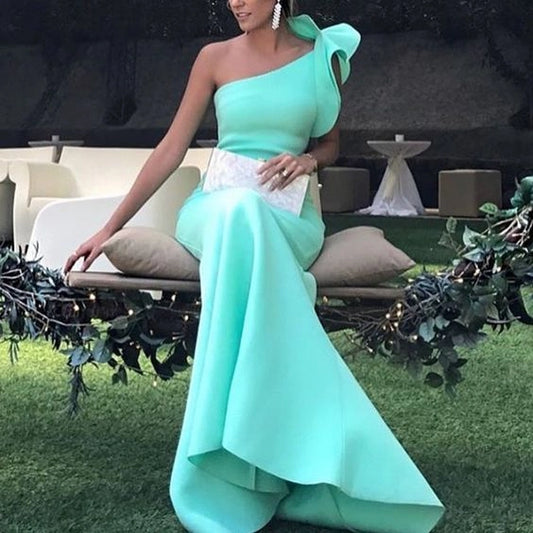 Mint green dress with one shoulder design and a three-dimensional bow, suitable for dinners