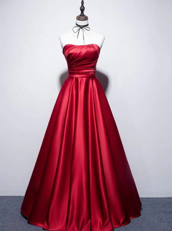 Red satin strapless dress with pleated upper design, high waist and large skirt suitable for dinners and parties