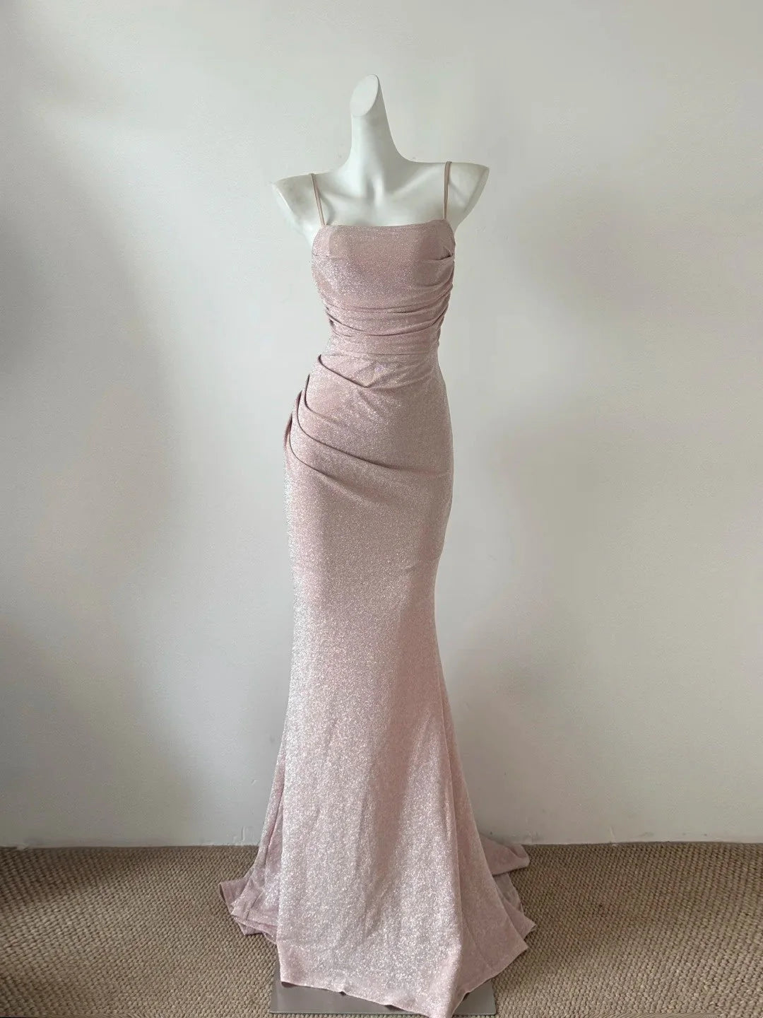 This light pink dress, with suspenders, pleats, and delicate shimmer, is so beautiful that it's perfect for a dinner party