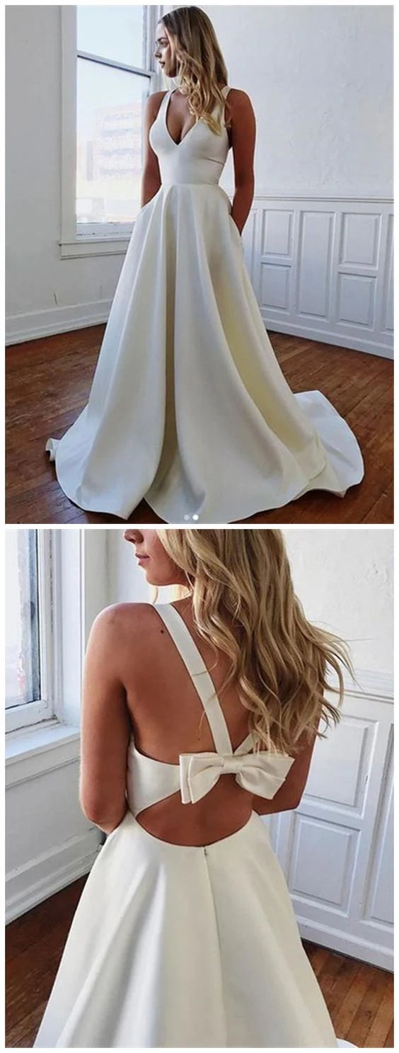 White deep V-neck sleeveless dress, with a deep V-neck cinched at the waist to highlight the figure, suitable for weddings, dinners, etc