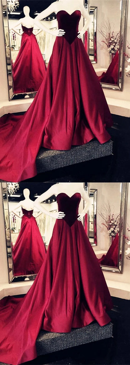Wine red satin dress with strapless heart-shaped neckline, high waist, and large skirt with trailing hem, suitable for dinner parties