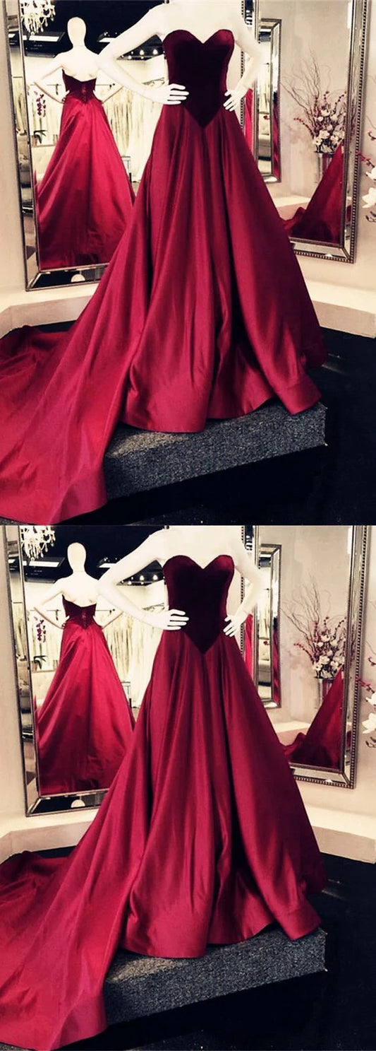 Wine red satin dress with strapless heart-shaped neckline, high waist, and large skirt with trailing hem, suitable for dinner parties