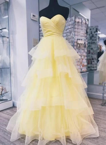 Yellow dress with strapless cross design and mesh skirt suitable for occasions such as dinners and dances