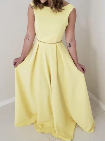 Yellow sleeveless long skirt with boat shaped neckline, thin waistband, and large skirt suitable for dinner parties